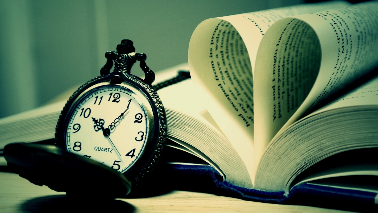 Picture of pocket watch and book on table