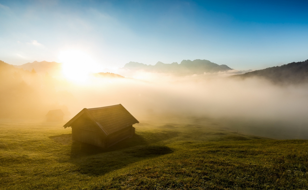 Morning misty cabin grassland landscape