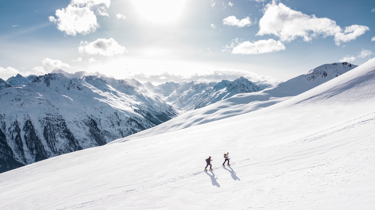 Two people hiking on snowy mountains