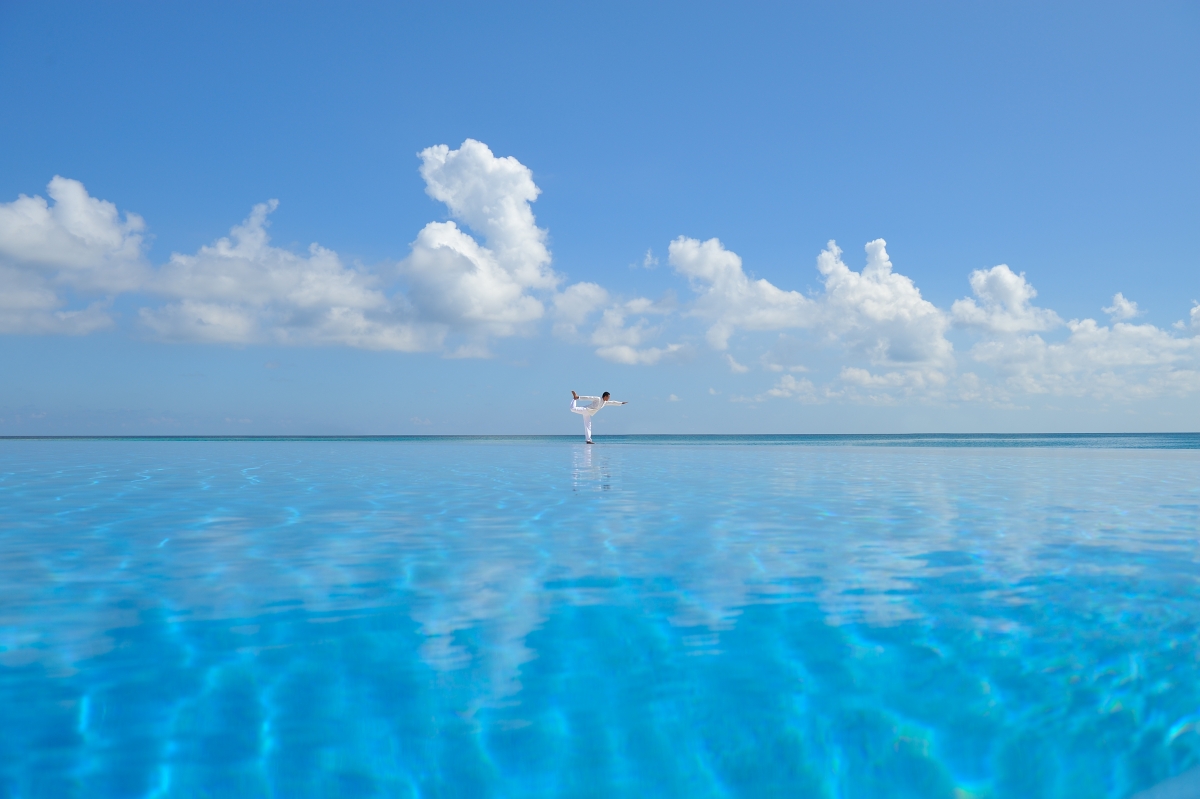 Seaside yoga exercise with clear water