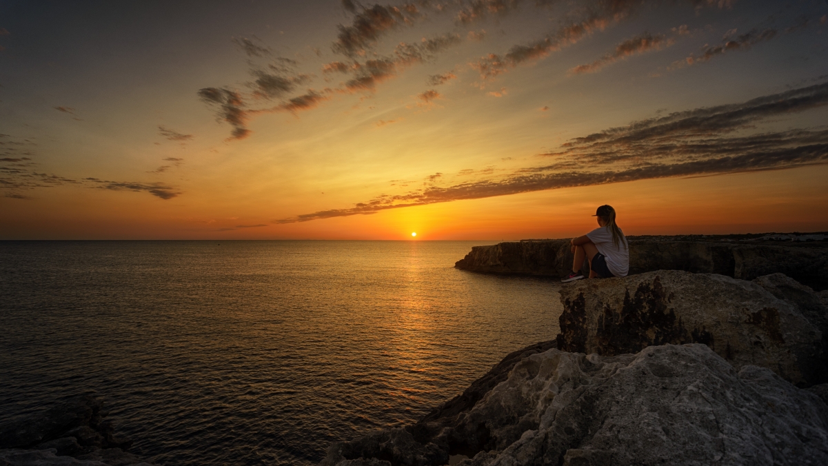 Girl on the coast watching the sunset and sunrise 5k