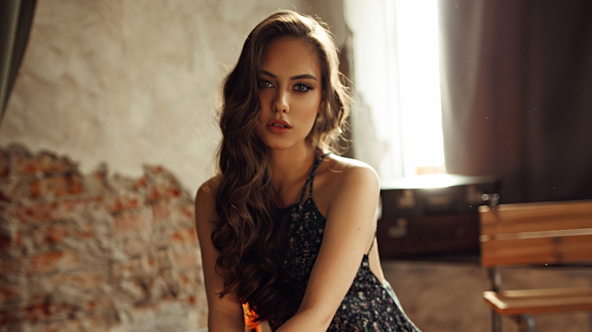 Beautiful foreign woman sitting on a chair staring