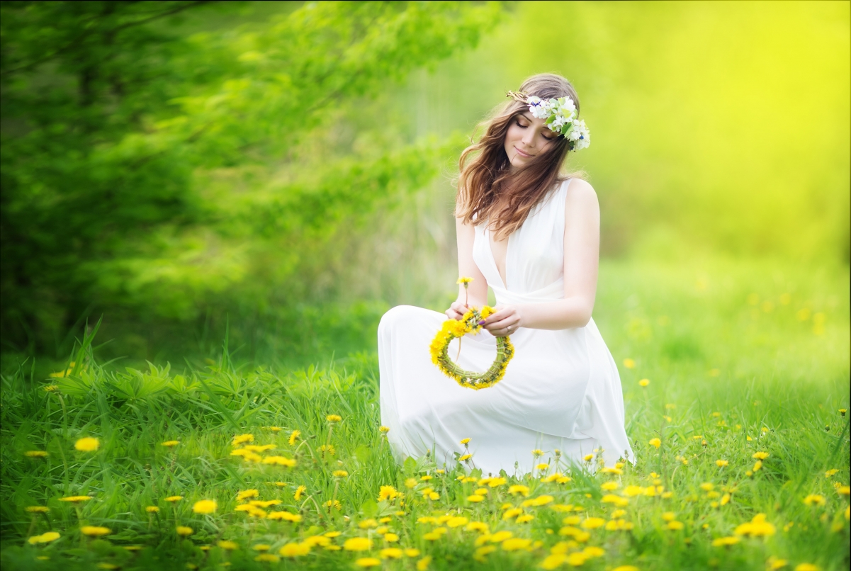 Brown-haired girl in wreath of yellow flowers