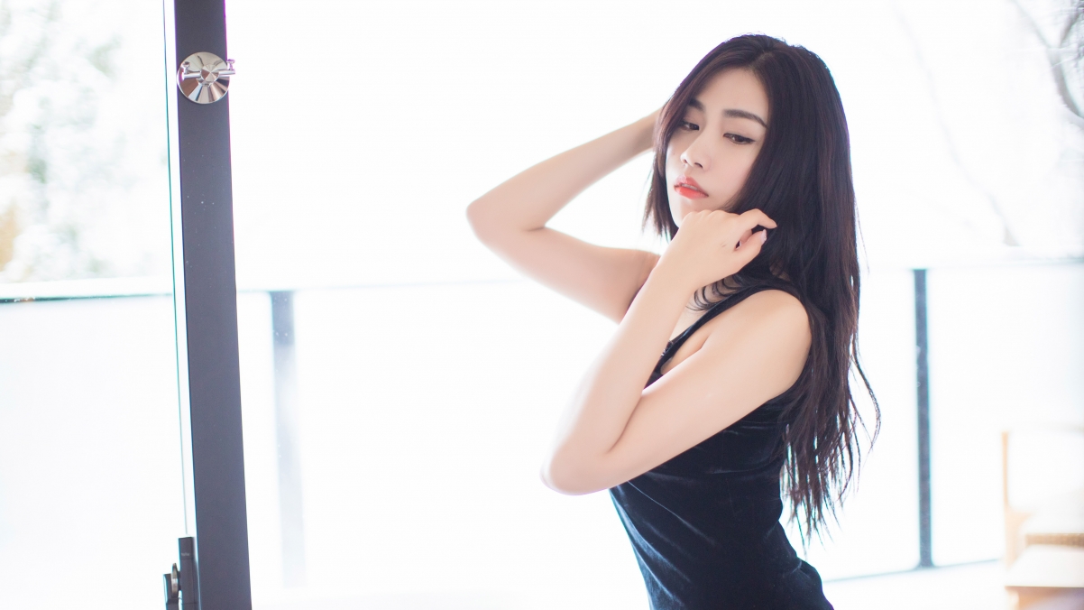 Beautiful woman in black dress with long hair promises