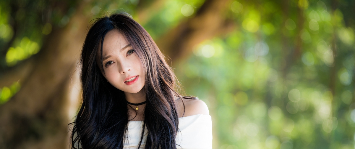 Long hair in white skirt on green background