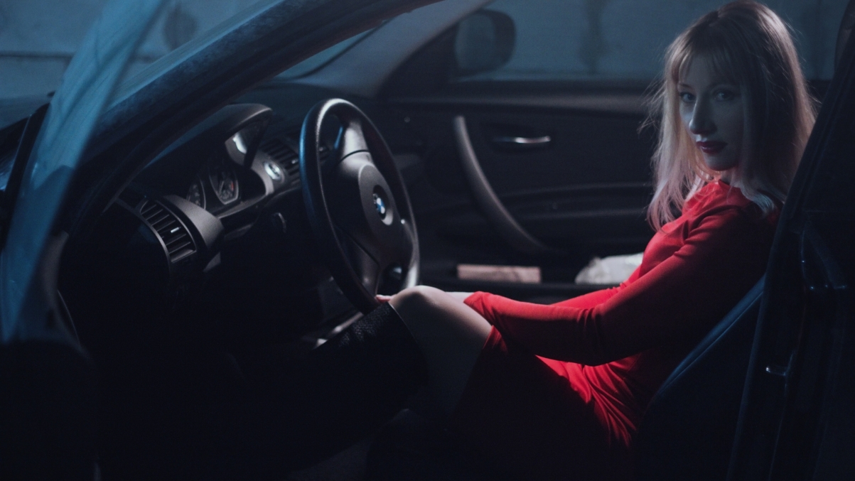The girl in the car dressed in red whith
