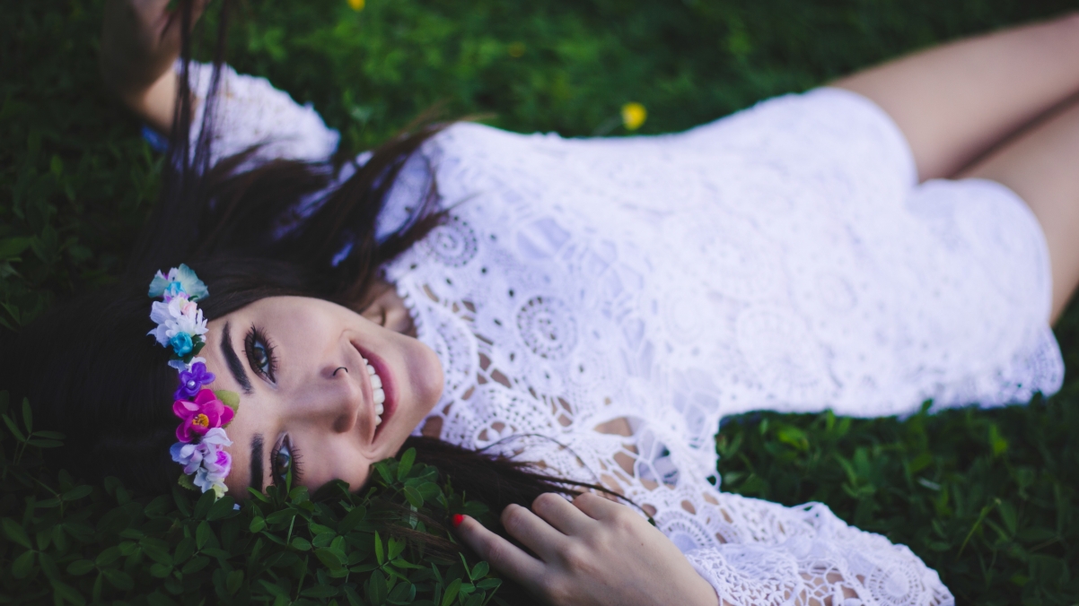 Smiling girl in white dress with wreath