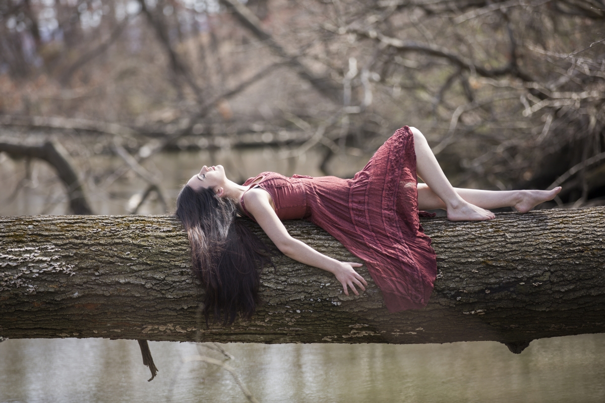 Beautiful girl lying on the tree 4K wallpaper