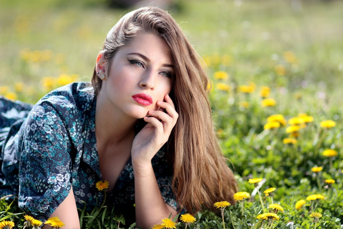 Beautiful women lying on the grass with flowers 4