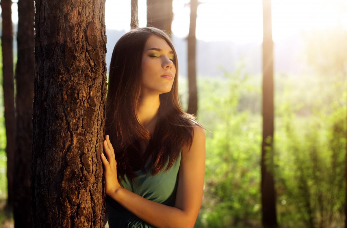 Girl with long hair in the woods with closed eyes photography
