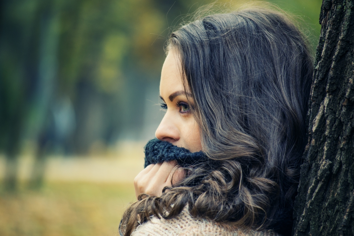 Girl looking into the distance with scarf outdoors