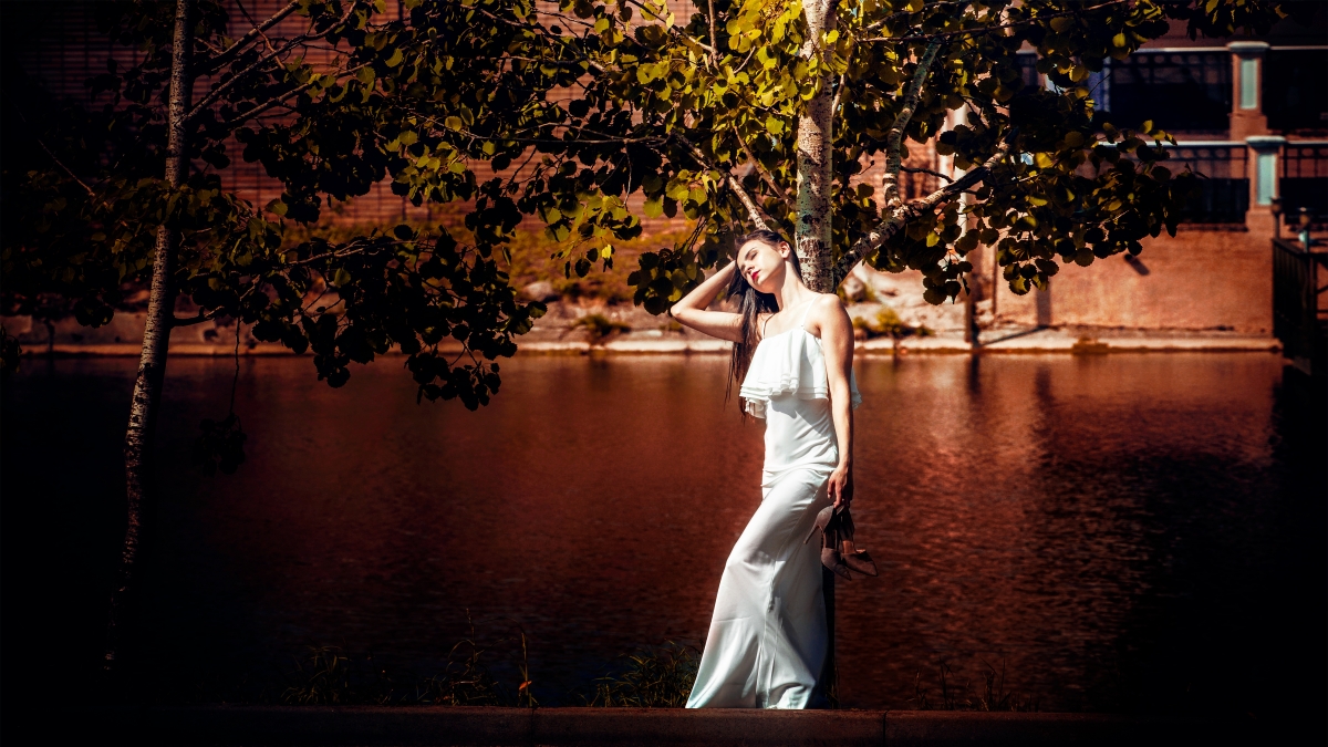 Girl in a white dress holding hands