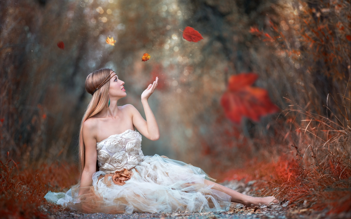 Girl leaves falling down white skirt