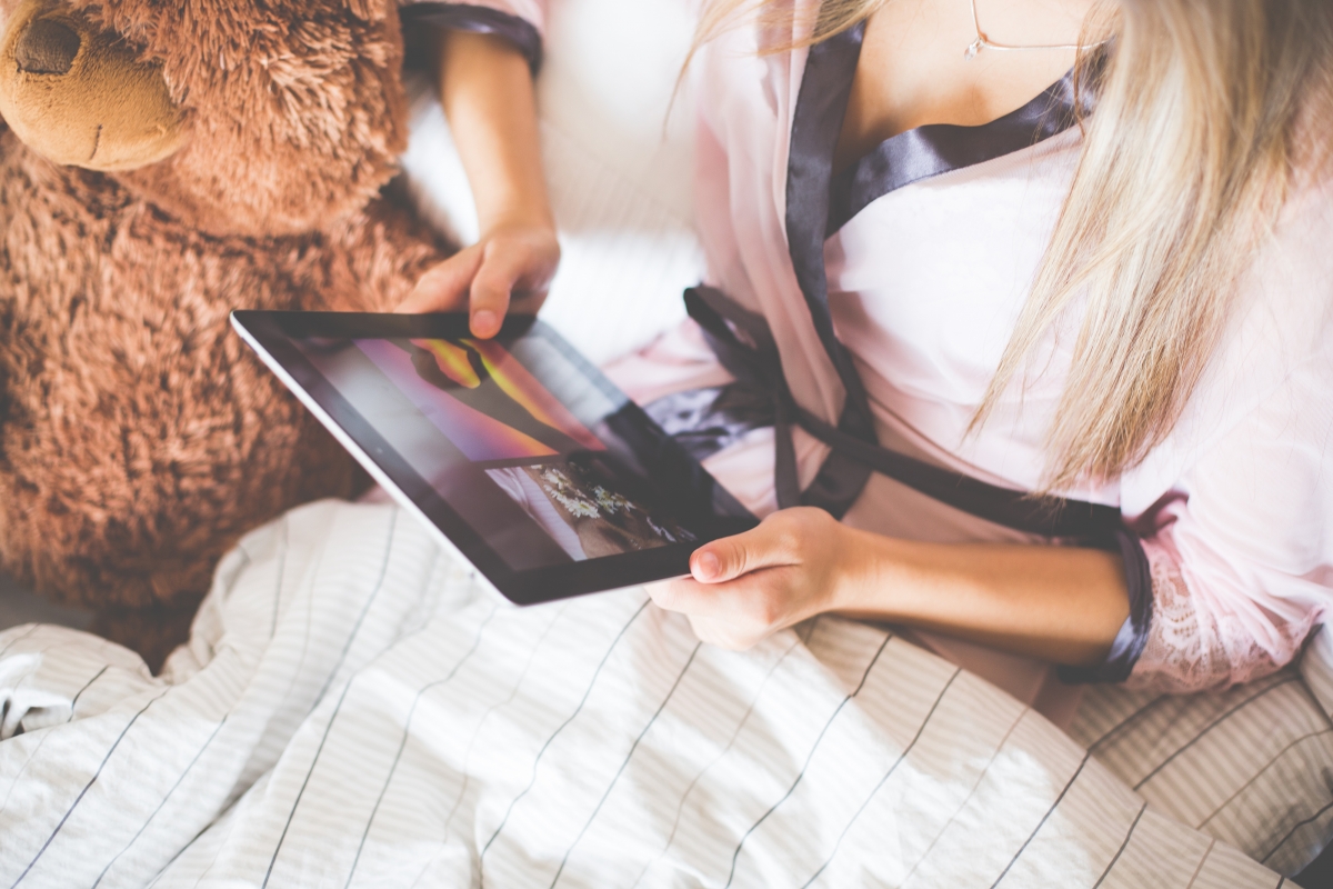 Beautiful woman using tablet to watch pictures
