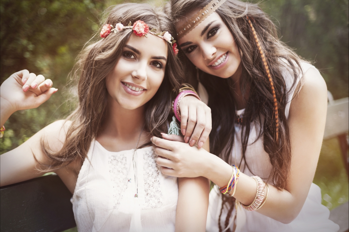 Two attractive women smiling with brown eyes