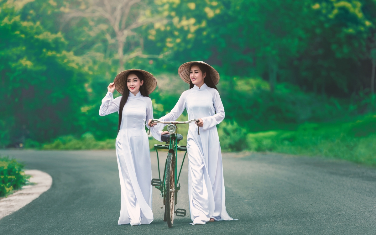 Two beautiful women walking with white hat