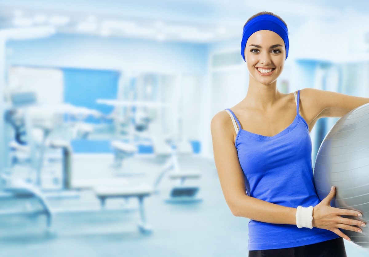 Young beautiful woman with fitness ball