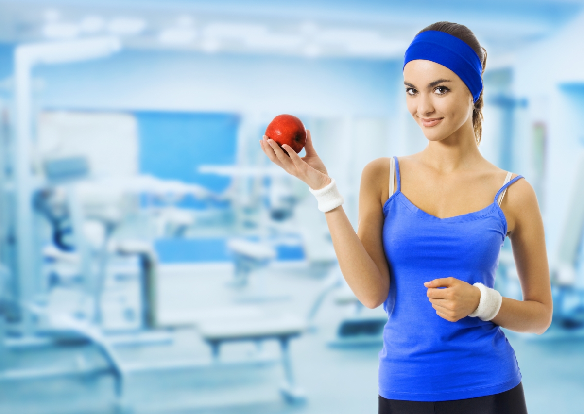 Gym woman in sportswear with red