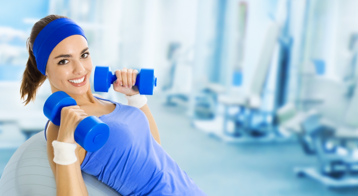 Young happy woman doing gym