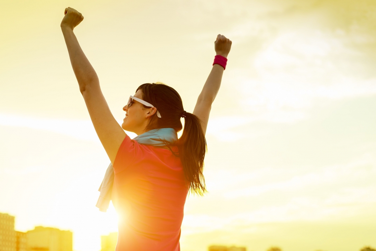 Healthy athletic girl smiling against the light
