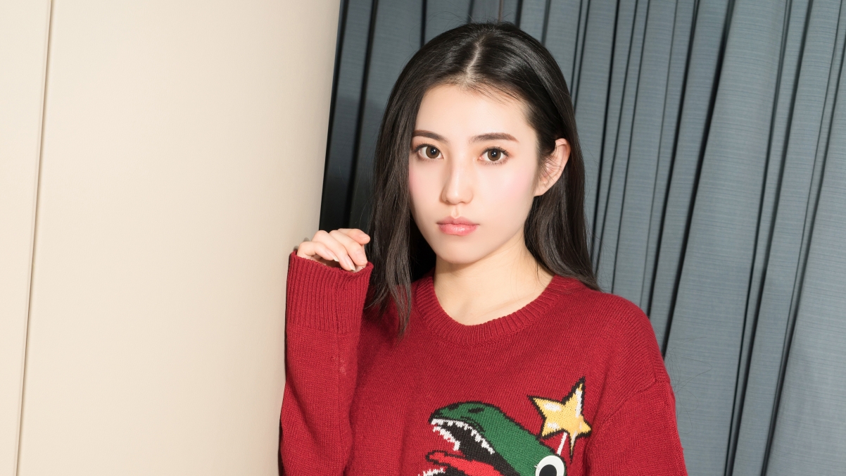 Beautiful girl in red sweater 4k wallpaper