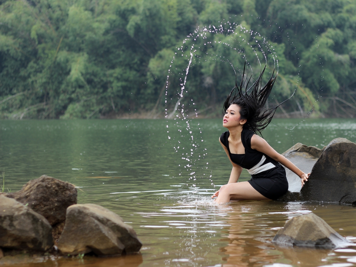 Beautiful sexy woman with hair in river water