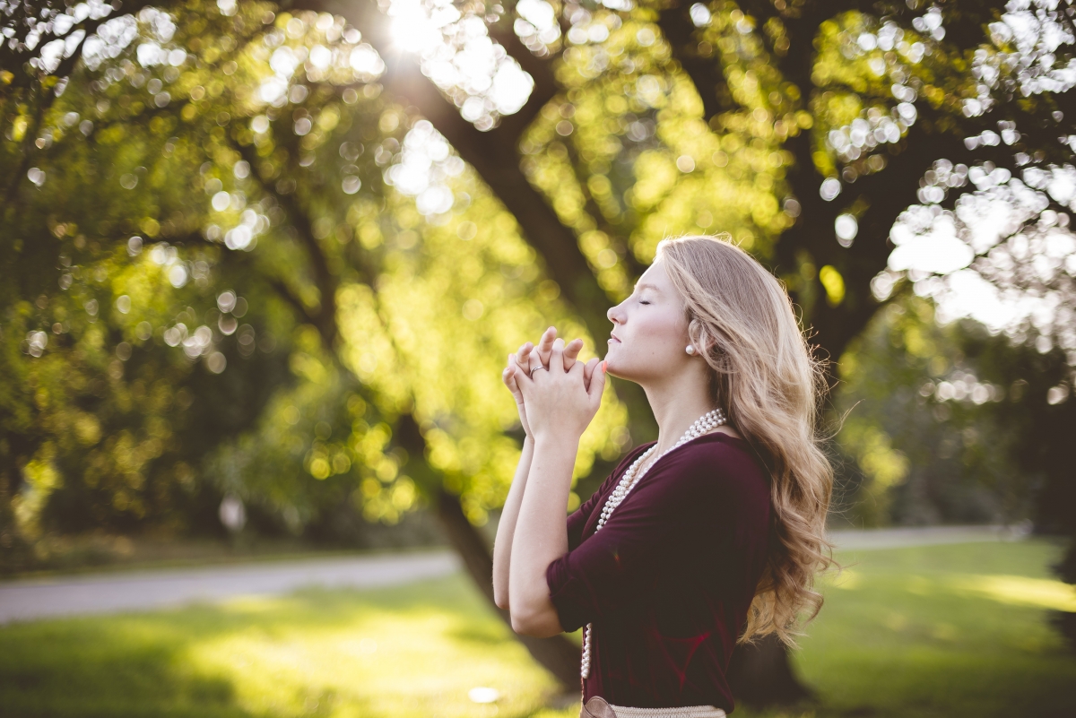 Beautiful blonde girl in the park tree 4K