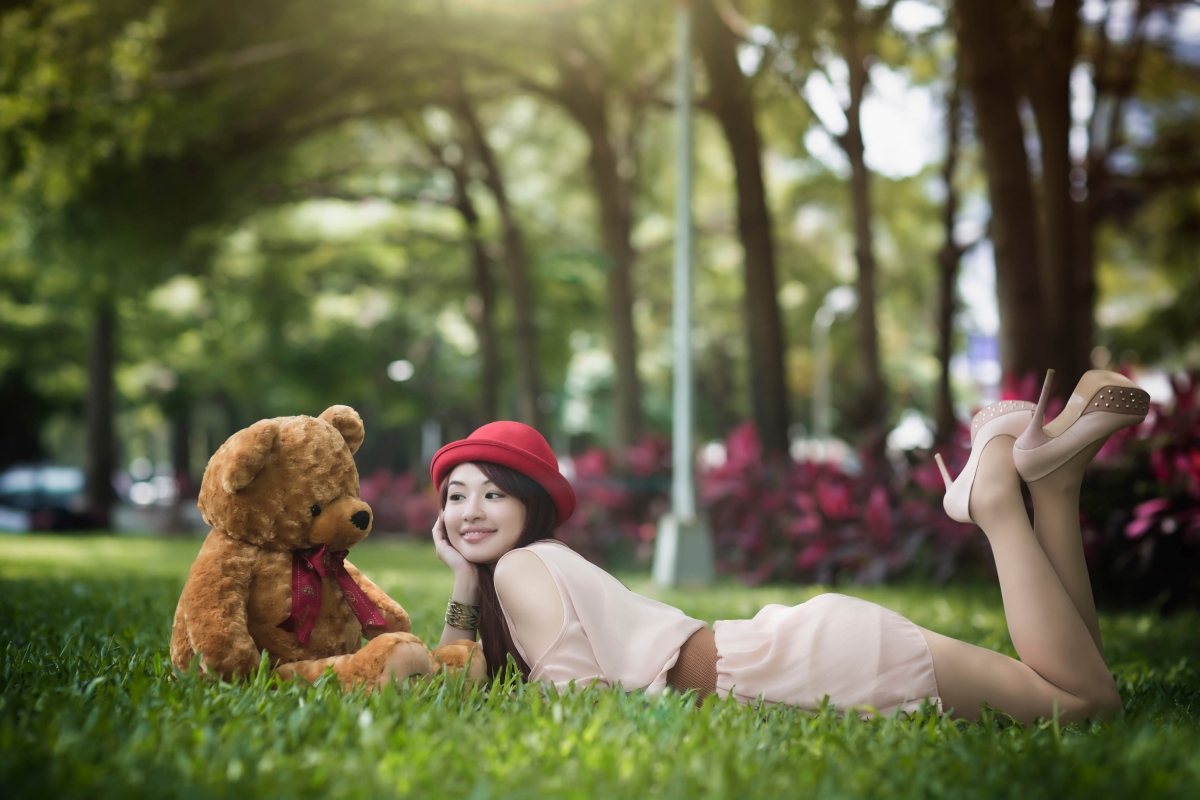Beautiful woman lying on the grass in the park 4