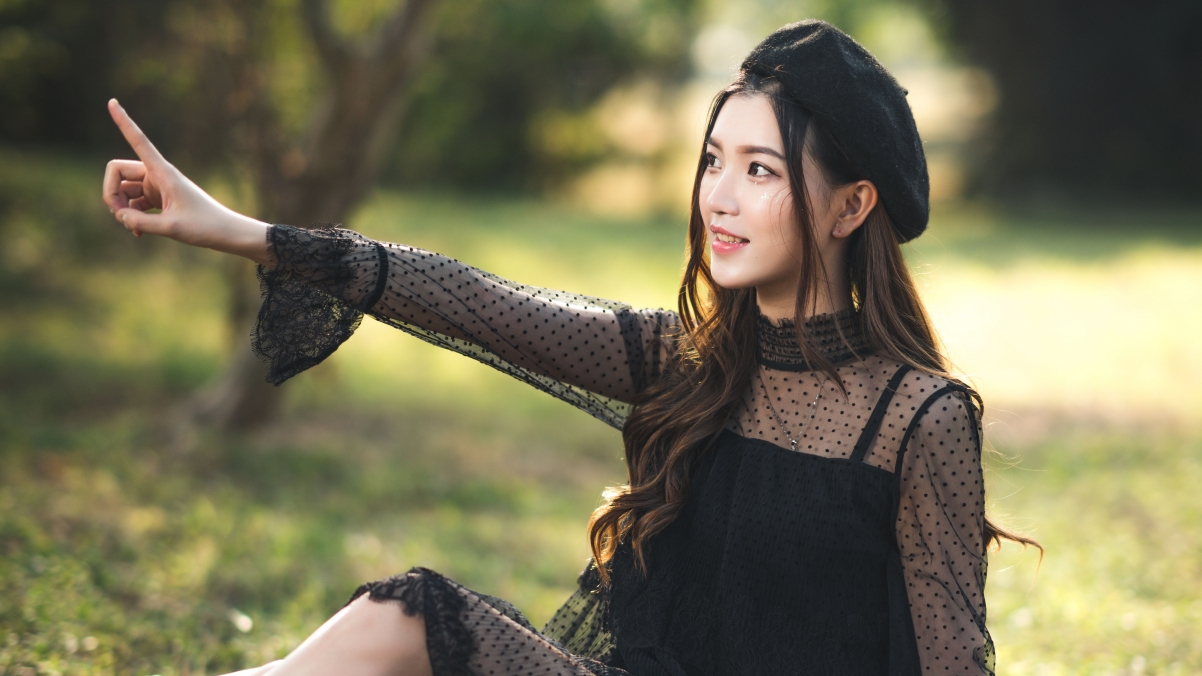 Beautiful woman in black lace base skirt in park