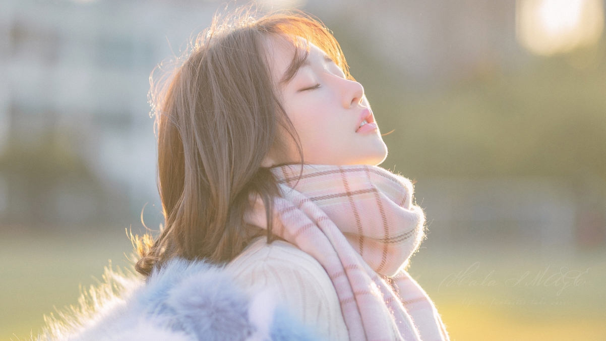 Beautiful scarf with closed eyes in winter