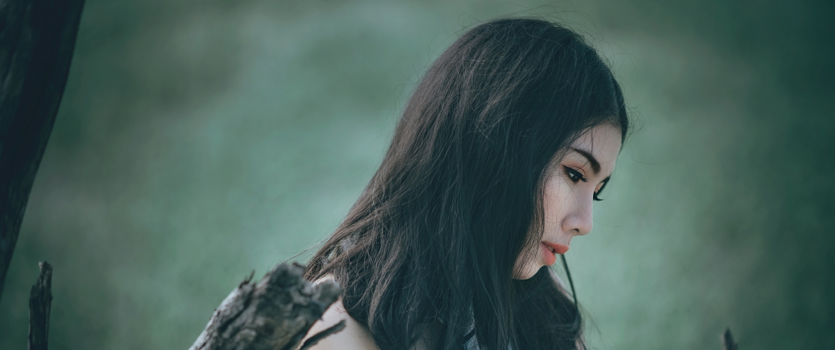 Beautiful long-haired beauty with bowed head in a beautiful mood