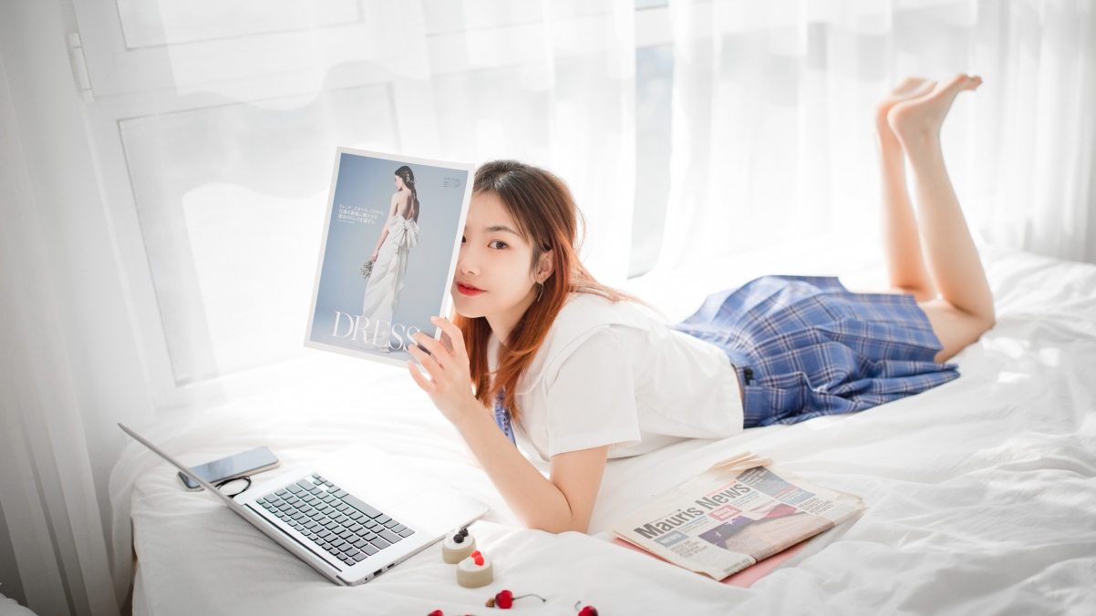 Bed beauty magazine computer phone