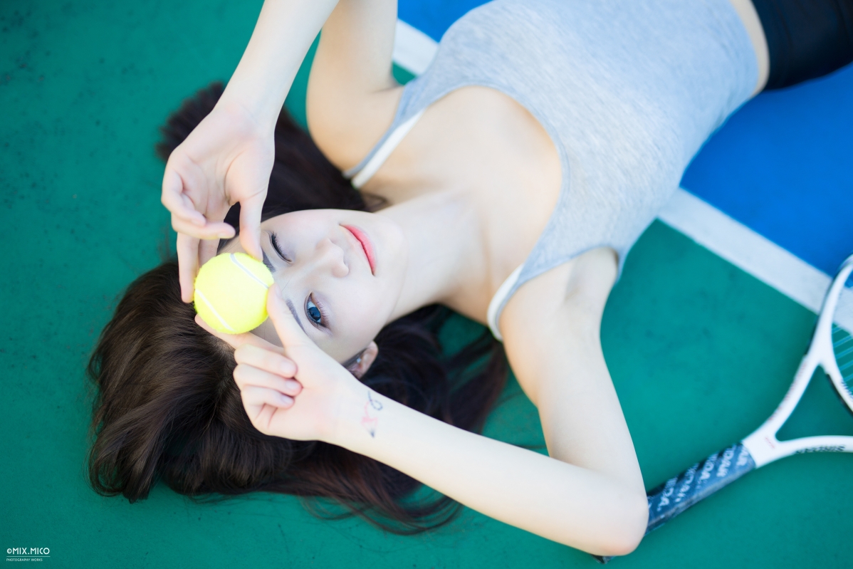 Cute tennis ball with one eye closed