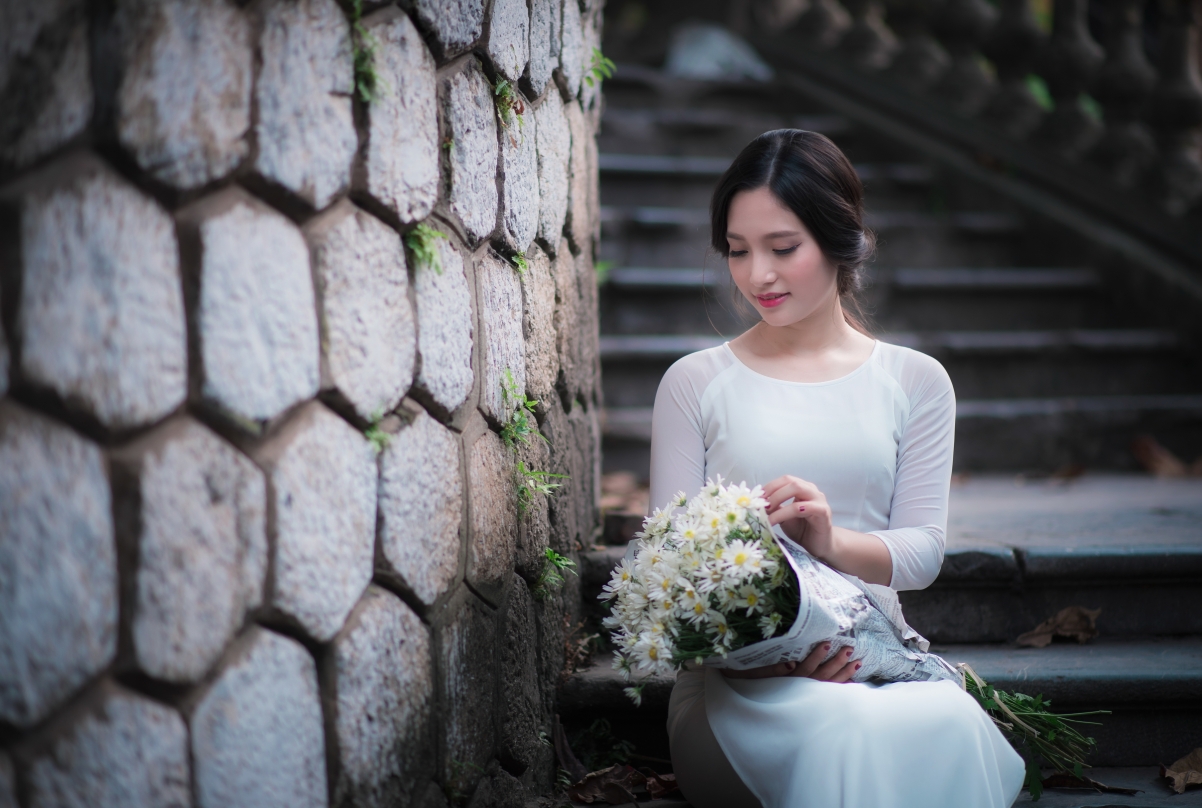 Beautiful woman in white skirt, ladder, flowers