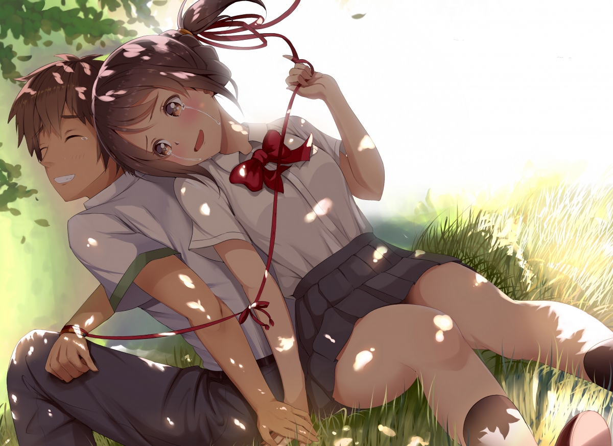 Sitting on the grass and leaning together