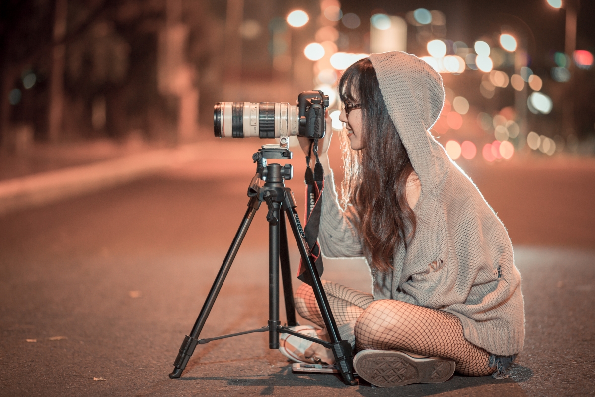 Photographer girl with camera at night