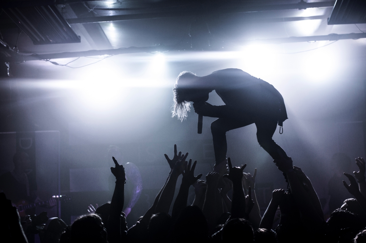 Black and white photo of singer chasing stars in concert