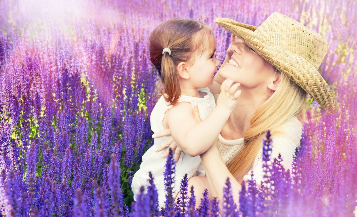 Girl playing with mother flower lavender