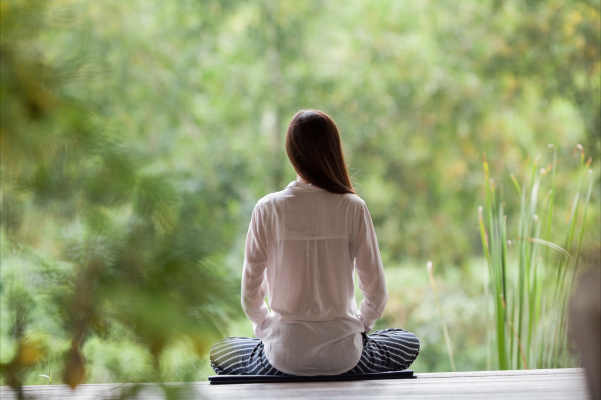 Girl sitting cross-legged meditating yoga