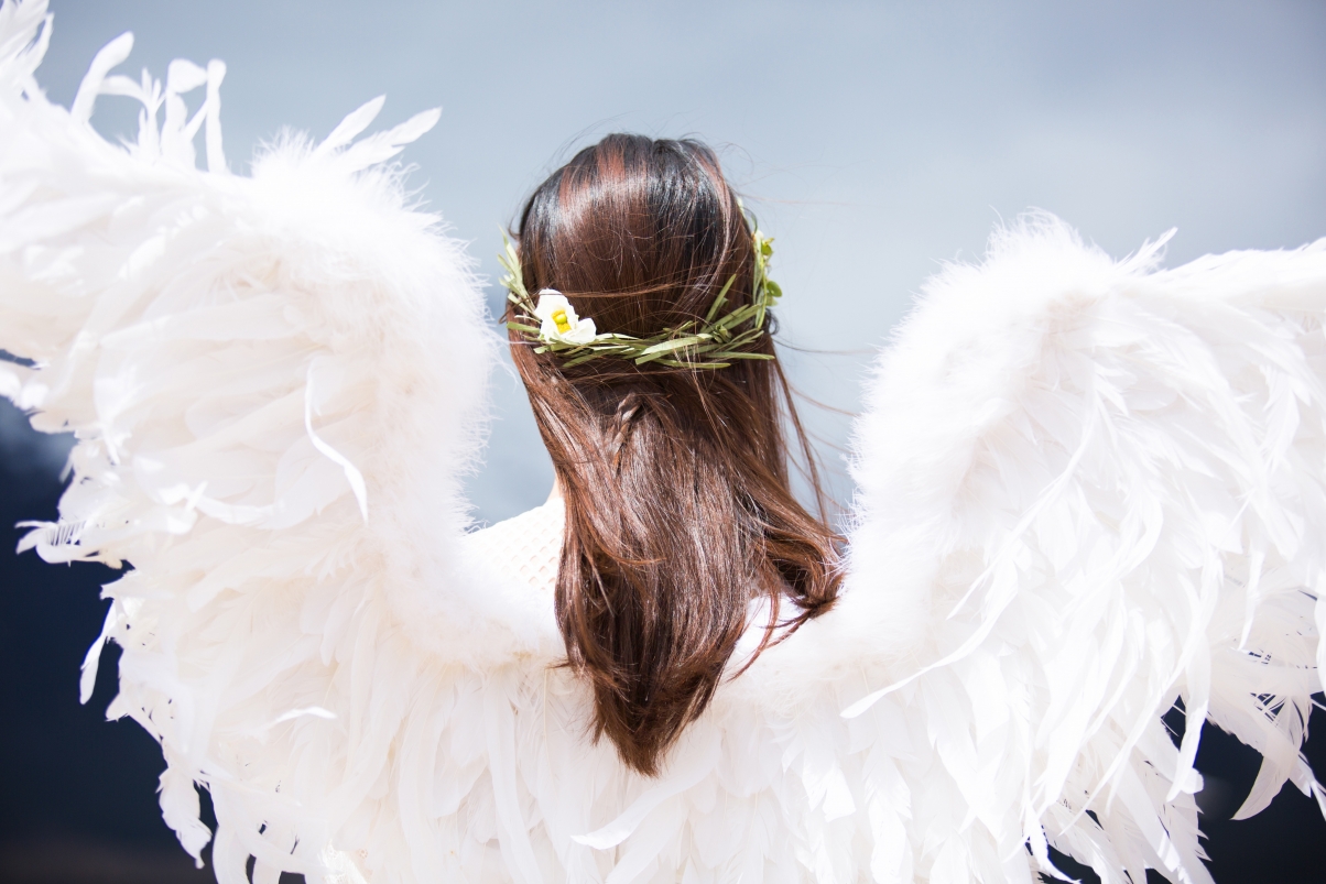 Girl back with white feather wings
