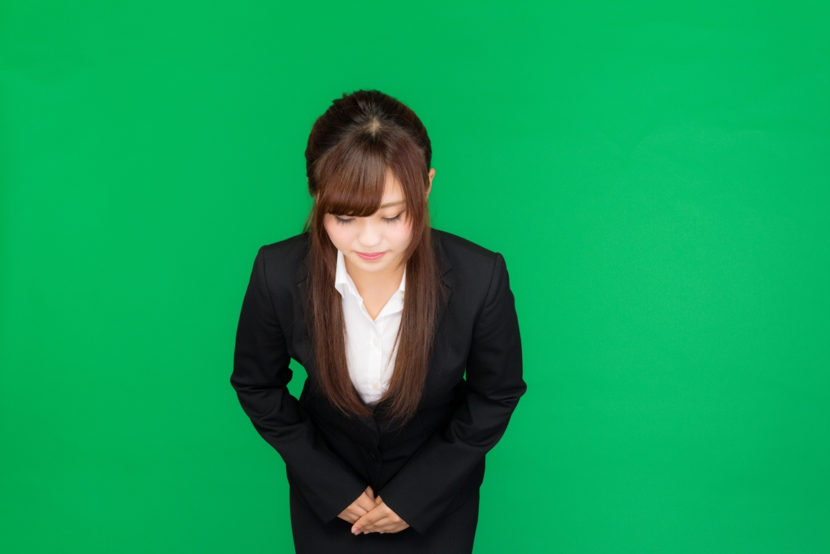 Saluting workplace woman on green background