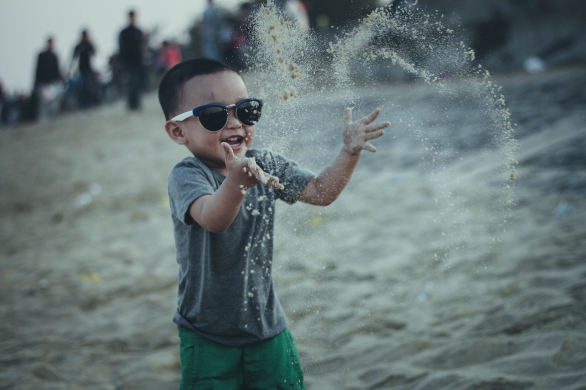 Boy and child fast fun on the beach