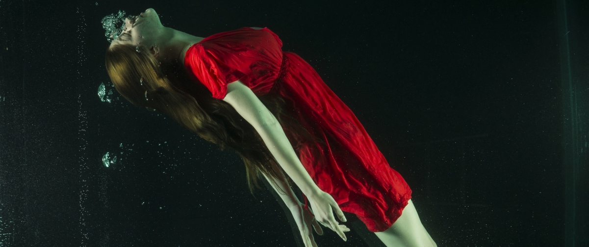 Underwater photography of girl in red