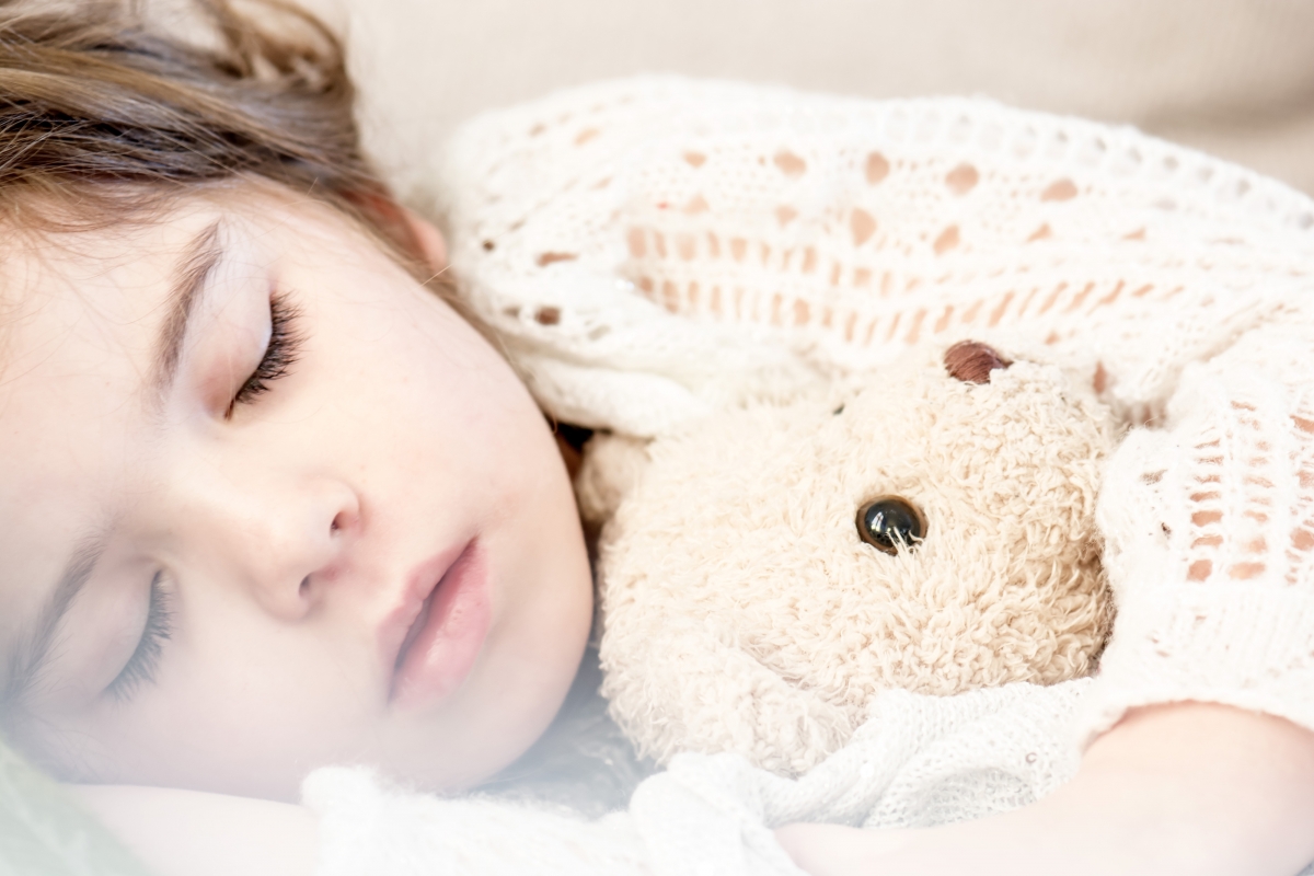 A child holding a bear