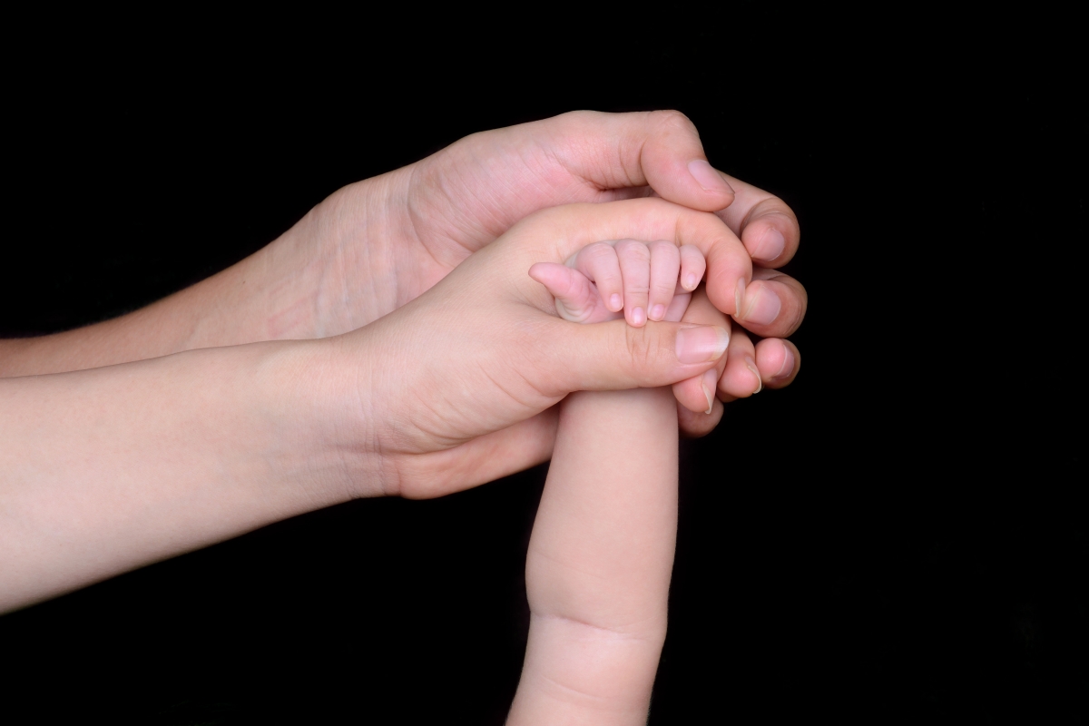 Mom and dad love to hold baby in hand