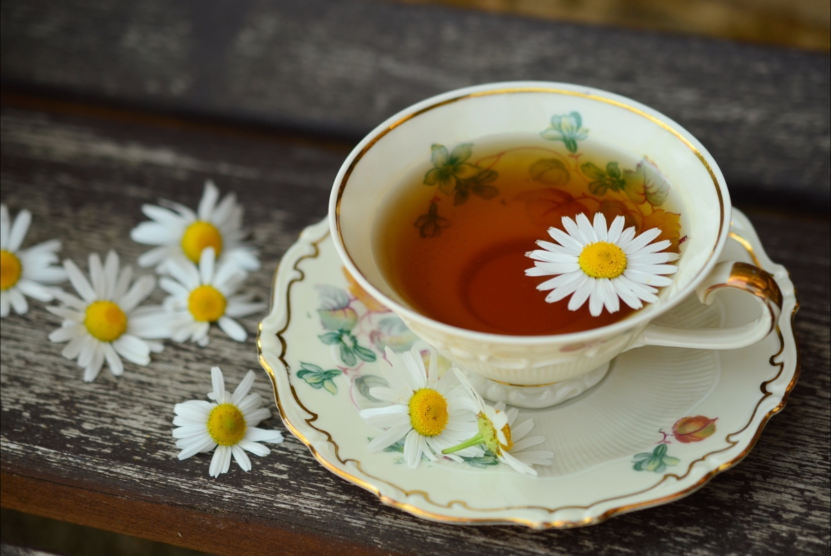A cup of flower tea on a wooden table 4k picture