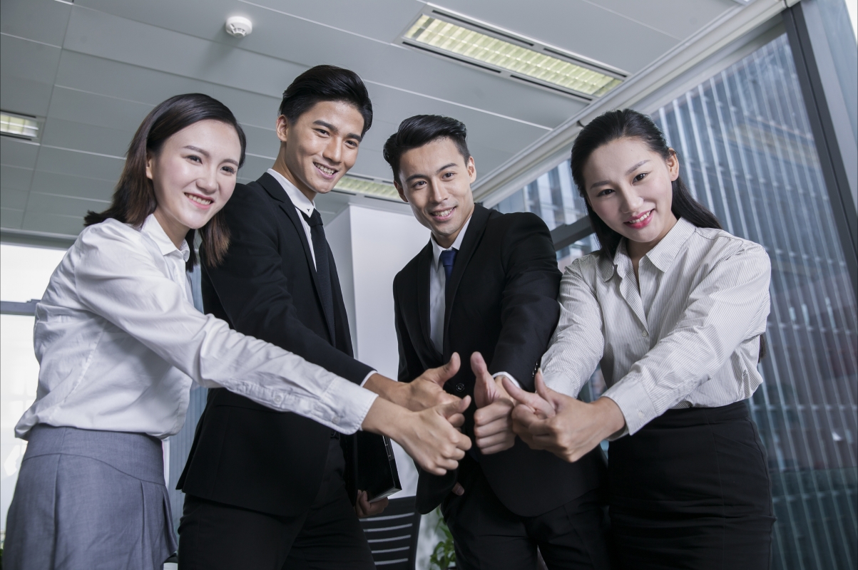 Business team thumbs up expressing agreement