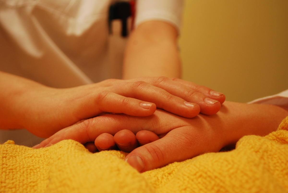 Gently hold the patient