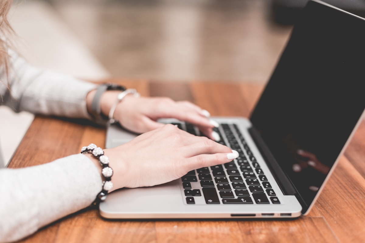 Young woman working typing pen