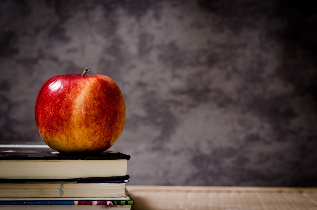 Picture of apples on stacked books